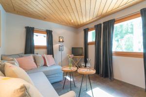 a living room with a couch and two tables at Chesa Survial 4 in Sils Maria