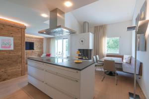 a kitchen with a island and a dining room at Residenza Edelweiss 5 3 in Sils Maria