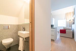 a bathroom with a toilet and a sink at Residenza Edelweiss 5 3 in Sils Maria +14 photos