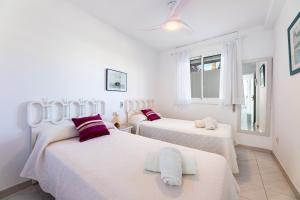 a white room with two beds and a window at Apartamento Veleta Puerto Pollensa in Pollença +15 photos