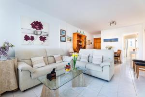 a living room with a couch and a table at Apartamento Veleta Puerto Pollensa in Pollença
