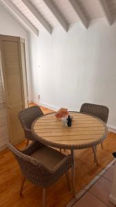 a wooden table and chairs in a room at Chill room front sea in Philipsburg
