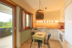 a kitchen with a table and chairs and a window at Chesa Tscheppa 1 in Sils Baselgia