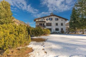 a house in the snow with trees at Chesa Tscheppa 1 in Sils Baselgia
