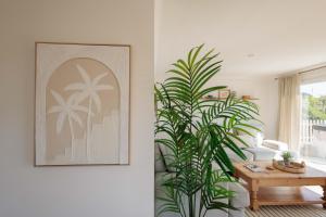 a living room with a table and a plant at Hot Tub With A View - Christchurch Harbour in Christchurch