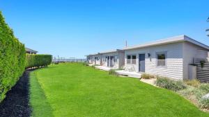 a row of houses with a green yard at The Inn Spot in Hampton Bays