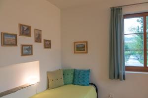 a bedroom with a bed and a window with at Chesa Clos in Sils Baselgia