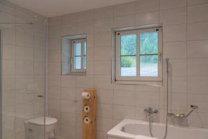 a bathroom with a shower and a toilet and a sink at Chesa Clos in Sils Baselgia +18 photos
