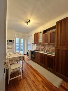 a kitchen with wooden cabinets and a table with a sink at L'Angolo di Mede in Mede