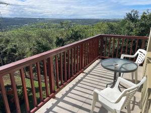 a balcony with a table and two chairs and a view at Fever Tree B&B in Gonubie Manor