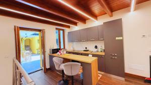 a kitchen with a counter and a table and chairs at Residence Besano in Besano