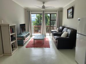 a living room with a couch and a table at Fever Tree B&B in Gonubie Manor