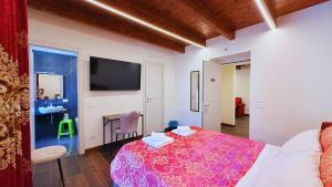 a room with a bed and a table and a tv at Residence Besano in Besano