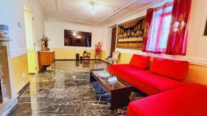 a living room with a red couch and a table at Residence Besano in Besano