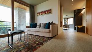 a living room with a couch and a table at Chesa Piol in Maloja