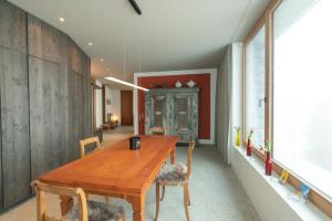 a dining room with a wooden table and chairs at Chesa Piol in Maloja