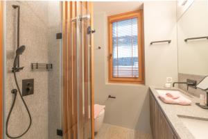 a bathroom with a shower and a toilet and a sink at Chesa Piol in Maloja +11 photos