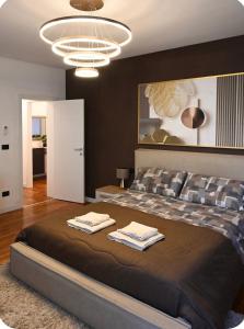 a bedroom with a large bed with two towels on it at Irpinia Maison in Quarto dʼAltino