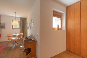 a room with a desk and a table with a window at Chesa Piol Studio in Maloja