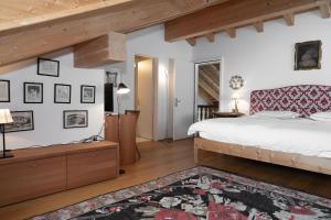 a bedroom with a large bed and wooden ceilings at Residenza Alpenrose 61 in Sils Maria