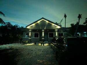 a house with a car parked in front of it at Shareen Homestay Morib in Banting +10 photos