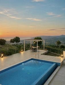 a villa with a swimming pool and a table at Villa Terra Rosa in Kritou Terra