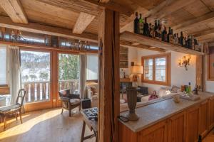 a kitchen with a counter with bottles on top of it at Chesa Cavril in Maloja