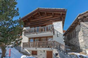 a house with a balcony on the side of it at Chesa Cavril in Maloja