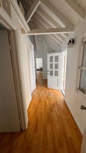 an empty room with a wooden floor and white walls at Chill room front sea in Philipsburg +6 photos