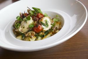 a bowl of food on a plate on a table at The Boathouse in Rollesby