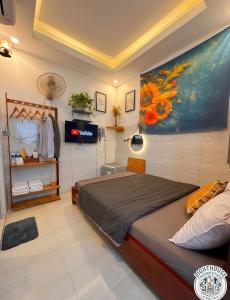 a bedroom with a bed and a painting on the wall at Lighthouse Homestay Vũng Tàu in Vung Tau +64 photos