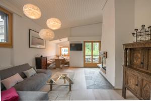 a living room with a couch and a table at Chesa Maria 7 in Sils Maria