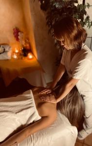 a woman sitting on top of a bed at LH Hotel Dvořák Tábor Congress & Wellness in Tábor