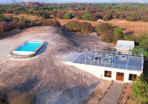 an aerial view of a house on a hill with a swimming pool at Thour Nature Resorts Jawai in Bera