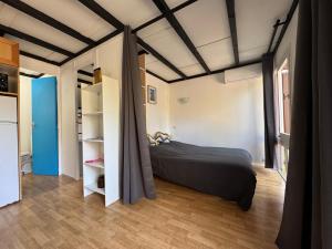 a bedroom with a bed and a book shelf at LES COTTAGES DE LEON in Léon +129 photos