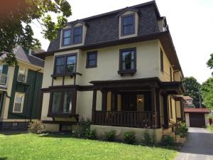 a yellow and green house with a black roof at Dartmouth House Inn in Rochester