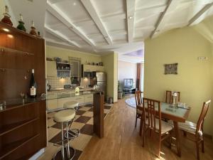 a kitchen with a table and chairs in a room at Дом в Аркадии - море рядом! in Odesa
