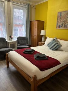 a bedroom with a bed with two towels on it at Boscombe Spa Hotel in Bournemouth +7 photos