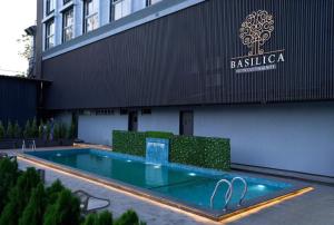 a swimming pool in front of a building at Basilica Resort, Lonavala in Lonavala
