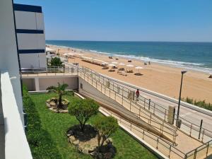 a view of the beach from the balcony of a condo at Apartahotel Estudio 221 in Matalascañas