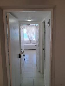 a hallway with a door leading to a room with a window at Apartahotel Estudio 221 in Matalascañas +12 photos