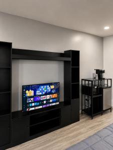 a room with a flat screen tv on a wall at Lake George Residence LLC in South Glens Falls