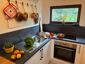 a kitchen with a sink and some fruits and vegetables at La Vigne - Han-sur-Lesse in Han-sur-Lesse