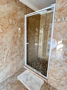 a shower with a glass door in a bathroom at The Social in Burgersfort +57 photos