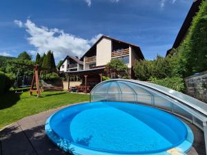 a swimming pool in the yard of a house at Dům Jaroslava in Černý Dŭl