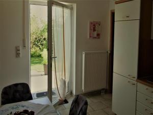 a kitchen with a door open to a patio at Ferienwohnung Meyer in Schönwald +17 photos