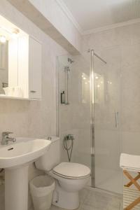 a bathroom with a toilet and a sink and a shower at Hostal La Llagosta in Llafranc