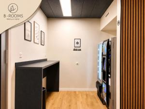 a room with a tv and a desk in a room at B-ROOMS Bleisure Hotel - Lugano district in Manno +25 photos