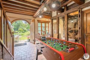 a room with a table with a foosball at Le cadre in Bonnières