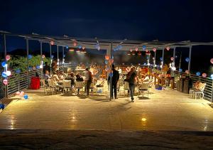 a group of people standing on a patio at night at Thour Nature Resorts Jawai in Bera